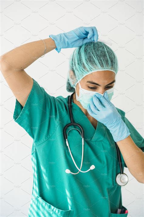 Female nurse tying surgical mask | High-Quality Health Stock Photos ~ Creative Market
