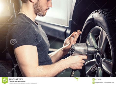 Mechanic Changing Car Wheel In Auto Repair Garage Stock Image Image Of Autorepair