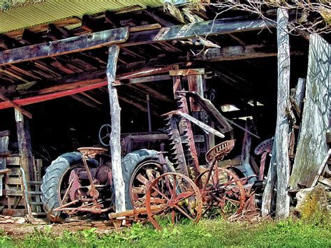 Old Tractor And Farm Equipment In A Run Down Shed Photograph By John