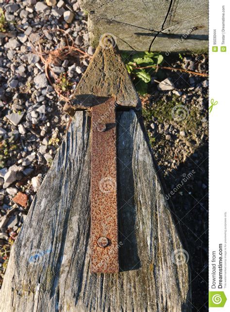 Old Rusty Arrow Attached To A Wooden Post Stock Photo Image Of Rusty