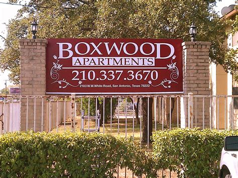 Boxwood Apartments signage located across from Big Lou's Pizza home of