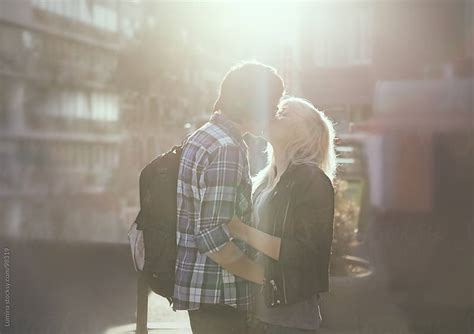 Teenage Couple Kissing On The Street By Lumina Stocksy United