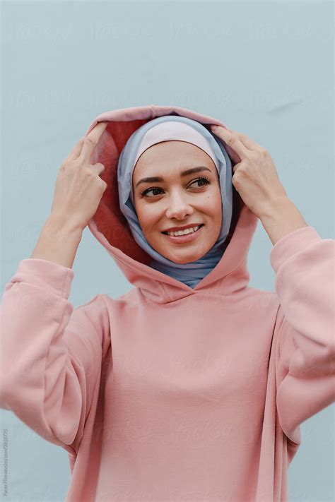 Modern Muslim Woman With Headscarf Puts On A Hood And Smiling Stylish
