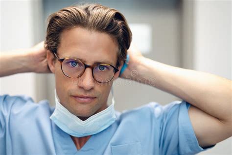 Male Doctor Removing Surgical Mask In The Ward At Hospital Stock Photo