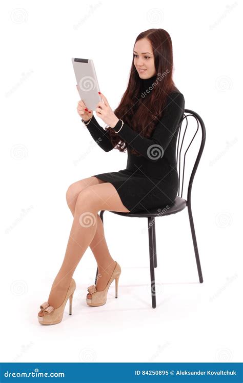 girl sits on a chair and looking at tablet pc stock image image of teen human 84250895