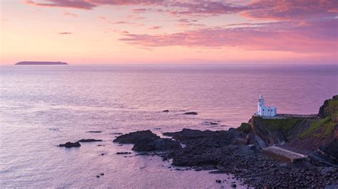Hartland Point Lighthouse And Lundy Island Beneath A