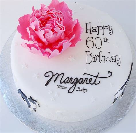 Round White 60th Birthday Cake With Pink Flower And Cursive Writing
