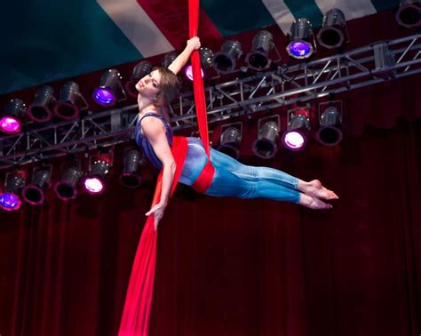 A Woman Is Performing Aerial Acrobatic Tricks On A Rope At A Circus