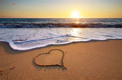 Valentines Love Heart On The Beach Sand Stock Photos Pictures