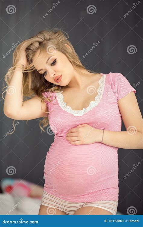 Happy Pregnant Woman Posing In Pink Blouse Attractive Young Blonde Glamour Girl At Home Stock