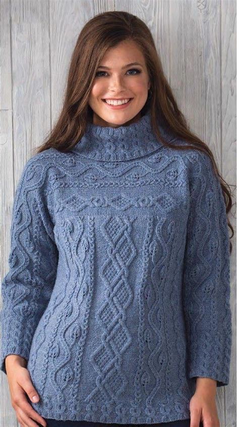 A Woman Wearing A Blue Cable Knit Sweater