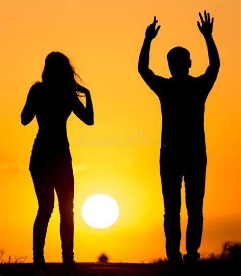 Silhouette Of A Guy And A Girl At Sunset Stock Image Image Of Beach