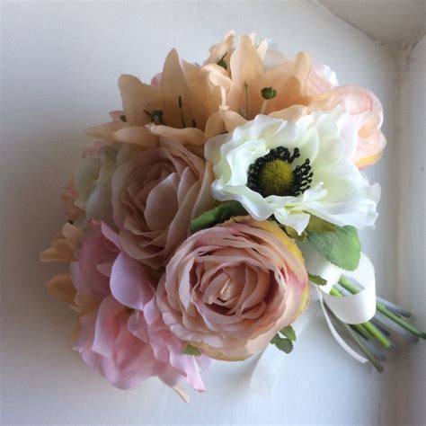 A Wedding Bouquet Featuring Peach Pale Pink And Ivory Flowers Ivory