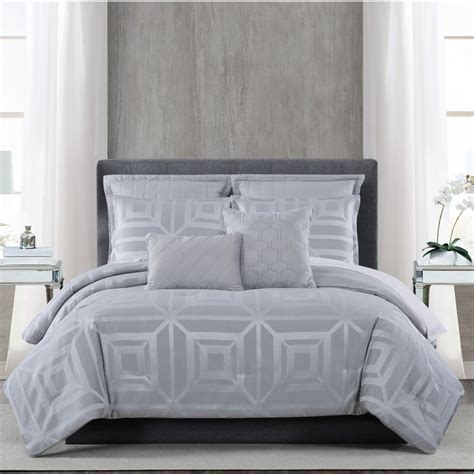 A Bed With White Sheets And Pillows On Top Of It In A Room Next To Two