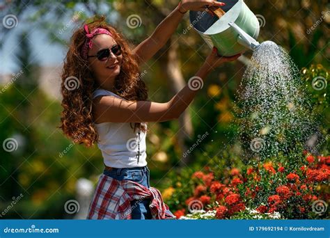 Woman In A Garden Watering Flowers Stock Photo Image Of Center Gardener