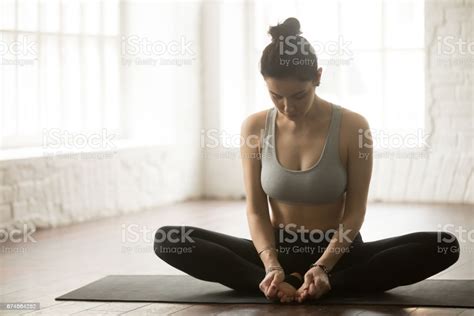 Posing with flowery chaplet and butterfly against sunlight. Young Sporty Woman In Butterfly Pose White Loft Studio Backgrou Stock Photo - Download Image Now ...