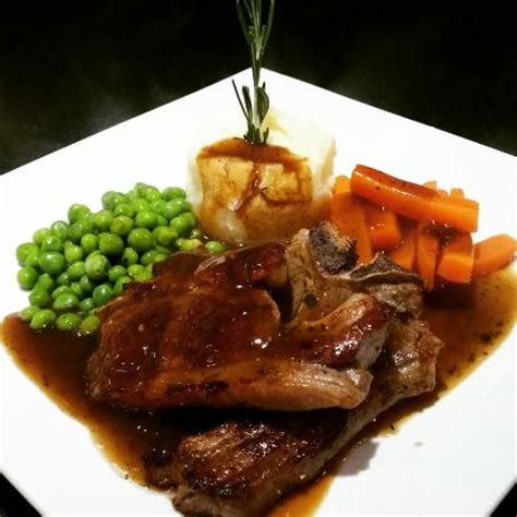 Serve with the potatoes and the mint sauce. Lamb chops in a minted gravy with mashed potatoes , peas ...