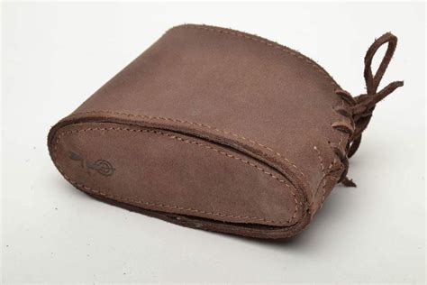 A Brown Leather Case With A Knot Around It