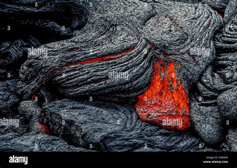 Molten Lava Rock That Glows From Its Extreme Heat Flows From An Stock