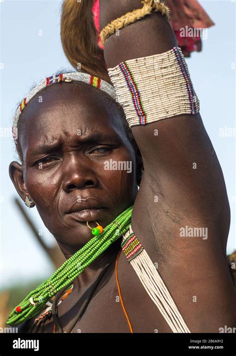 Toposa Tribe Woman In Traditional Clothing Dancing During A Ceremony