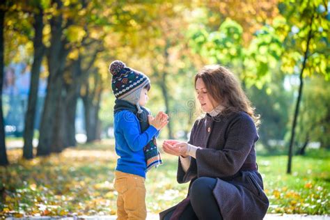 Mother And Baby Play In Autumn Park Parent And Child Walk In The