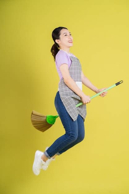 Premium Photo Young Asian Housewife Posing On Yellow Background