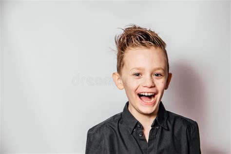Funny Guy In A Black Shirt Laughs With Open Mouth On A White Background