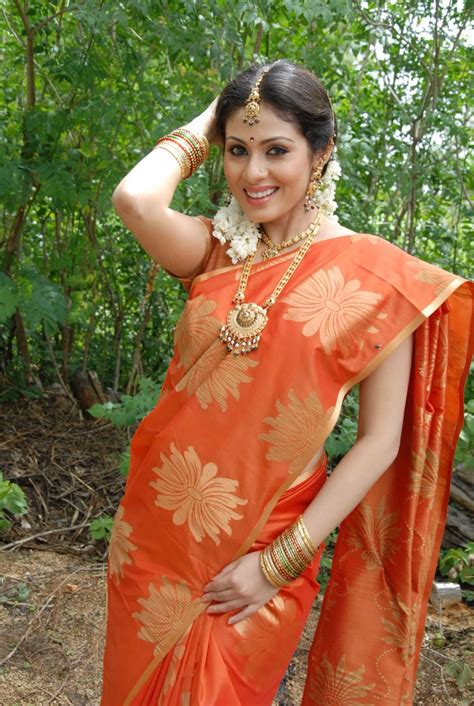 South Indain Actress Sada In A Beautiful Orange Saree With Gold Jewelry And Jasmine Flowers