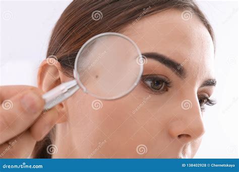 Dermatologist Examining Patient With Magnifying Glass In Clinic Stock
