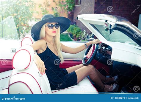 Outdoor Summer Portrait Of Stylish Blonde Vintage Woman Driving A Convertible Retro Car