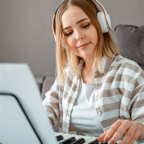 Woman In Headphones Playing Piano Music On Synthesizer From Notes
