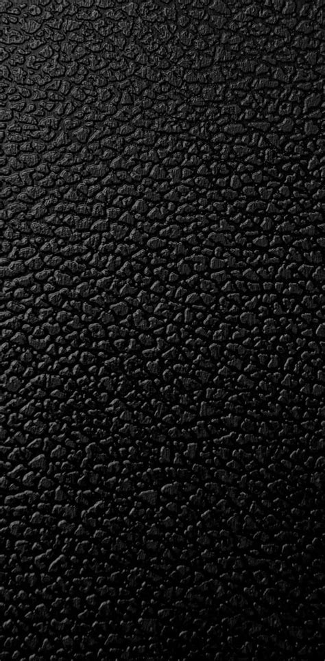The Texture Of Black Leather Is Shown In Close Up As If It Were Taken