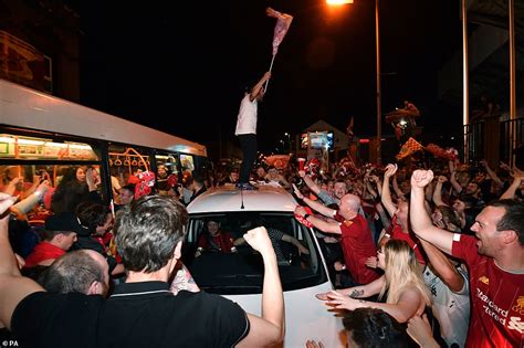 Liverpool Fans Clamber On Cars Straddle Traffic Lights And Scale Buses After Champions League