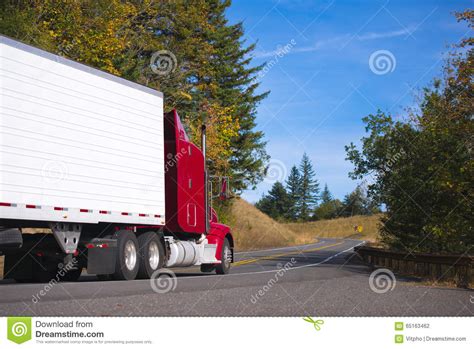 Red Semi Truck Rig And Trailer On Autumn Convoluted Highway Stock Photo