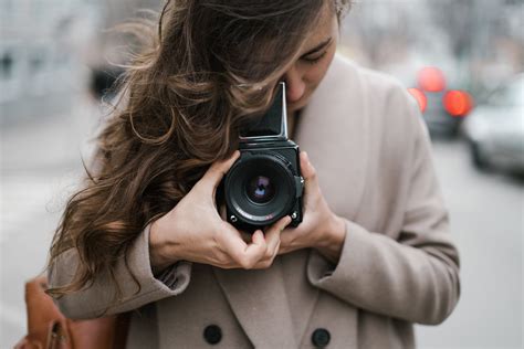 Young Woman Taking Photos With Old Fashioned Camera On Street · Free
