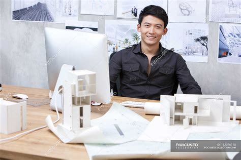 Chinese Male Architect Sitting In Office And Smiling — Table Designer