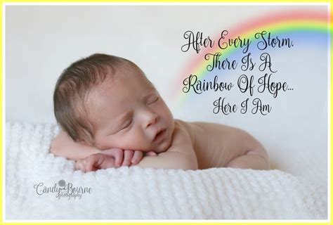 A Baby Laying On Top Of A White Blanket Next To A Rainbow And Text That