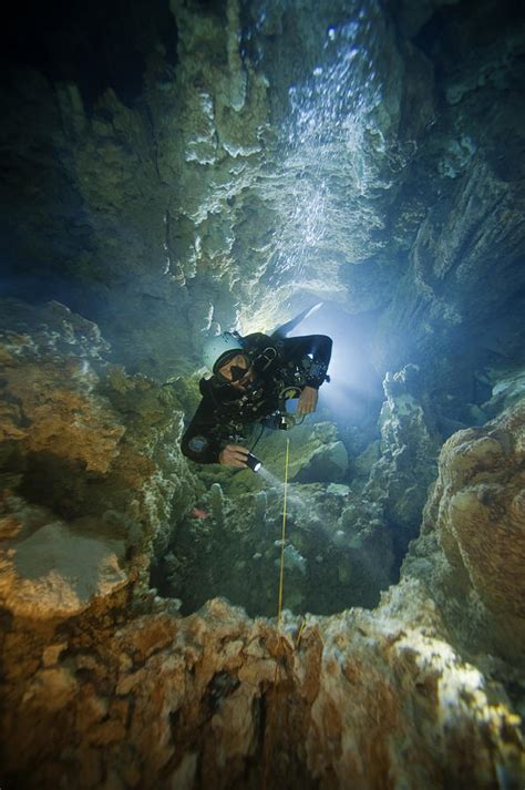 A Diver Ascends A Deep Shaft In Dans Photograph By Wes C Skiles