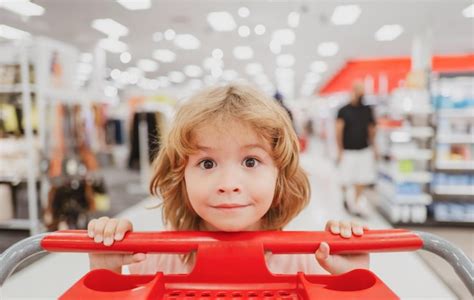 Premium Photo Child With Shopping Cart In A Grocery Store Funny Kid