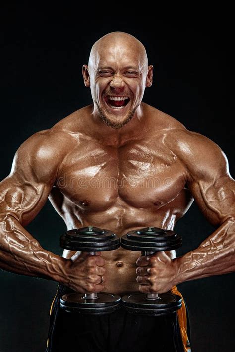 Strong And Fit Man Bodybuilder Sporty Muscular Guy With Dumbbells