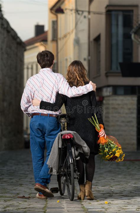 Young Man And Woman Walking Away Together Stock Photo Image Of Flower