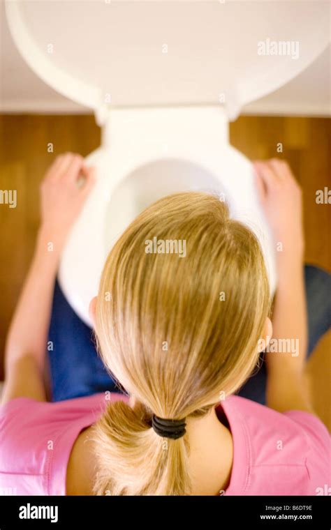 Bulimia Young Woman Crouching Over A Toilet Bowl Bulimia Nervosa Is A