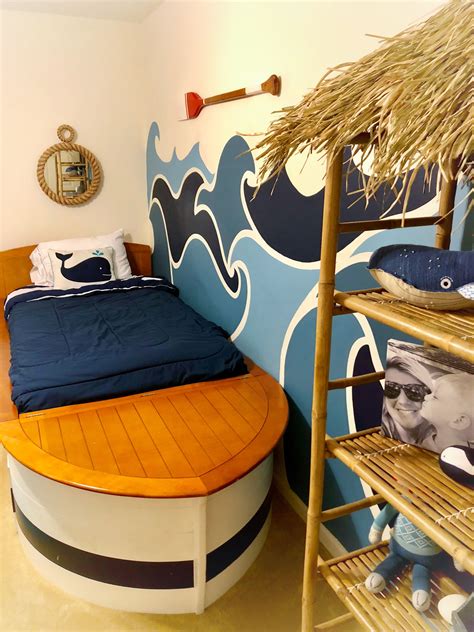 A Room With A Bed Shelf And Palm Tree On The Wall Next To It