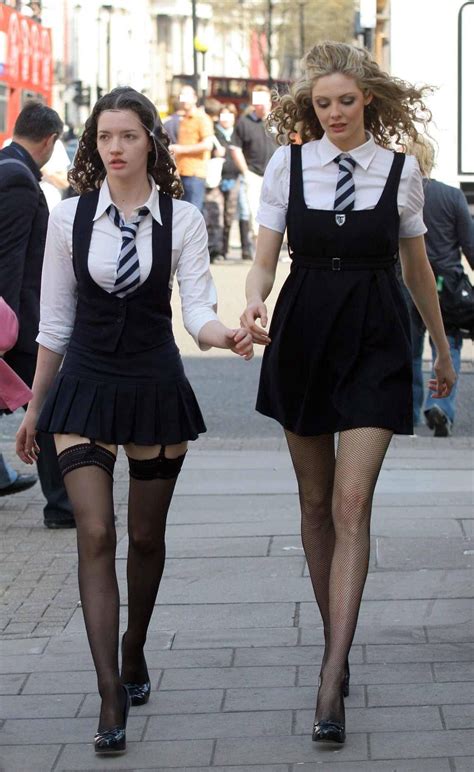 Two Schoolgirls Wearing Black Sheer And Fishnet Stockings And Black