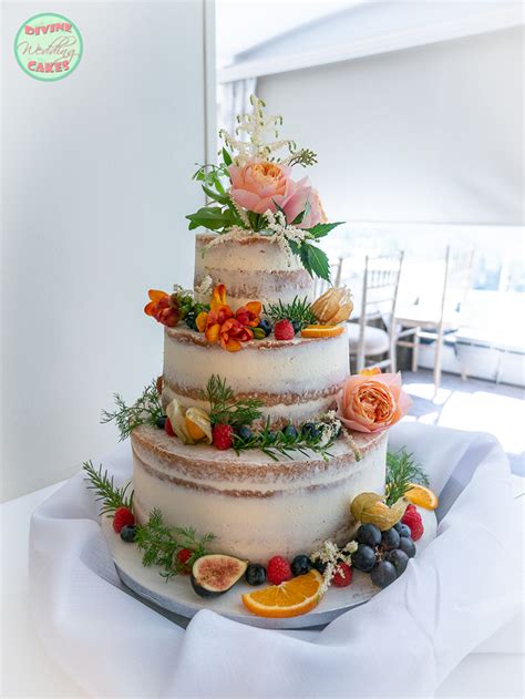 semi naked cake with fresh flowers and fruits wedding cakes in devon and cornwall divine wedding