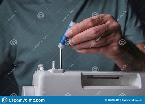 Hands Putting Thread Spool On Sewing Machine Close Up Stock Image
