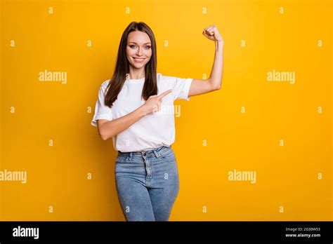 Photo Portrait Of Strong Girl Pointing Finger At Biceps Isolated On Vivid Yellow Colored