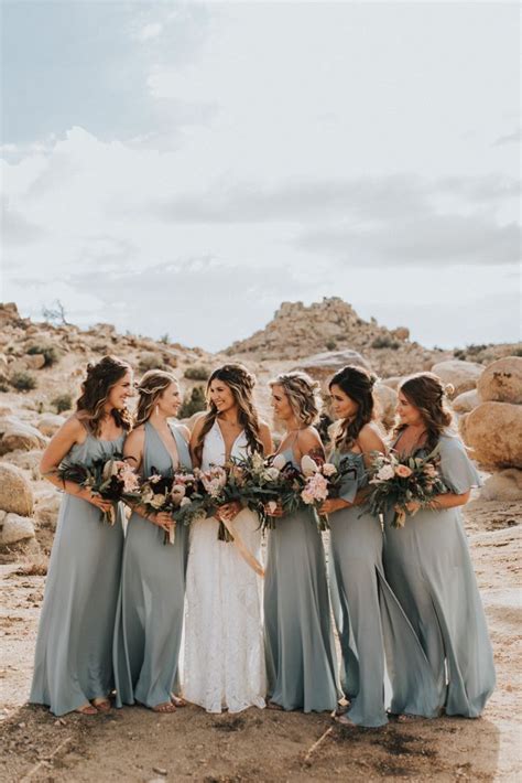 these bridesmaids looked elegant in mismatched blue gowns at this desert wedding image by
