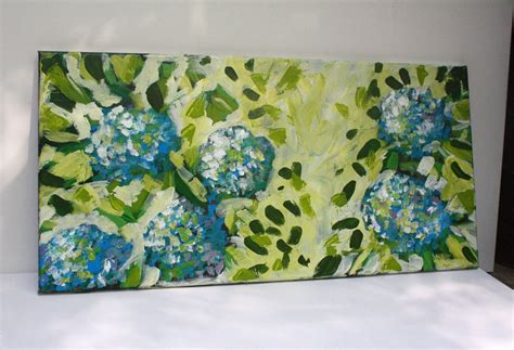 A Painting With Blue And Green Flowers Painted On It S Canvases Next To