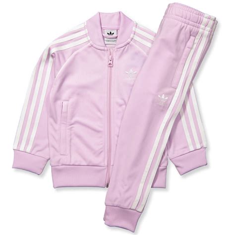 Featuring a frontal zip fastening, gold branding and two sequinned pockets, the long sleeve jumper has plenty of frills and a nifty hood. Adidas Originals - Pink tracksuit - AERPNK - Rosa